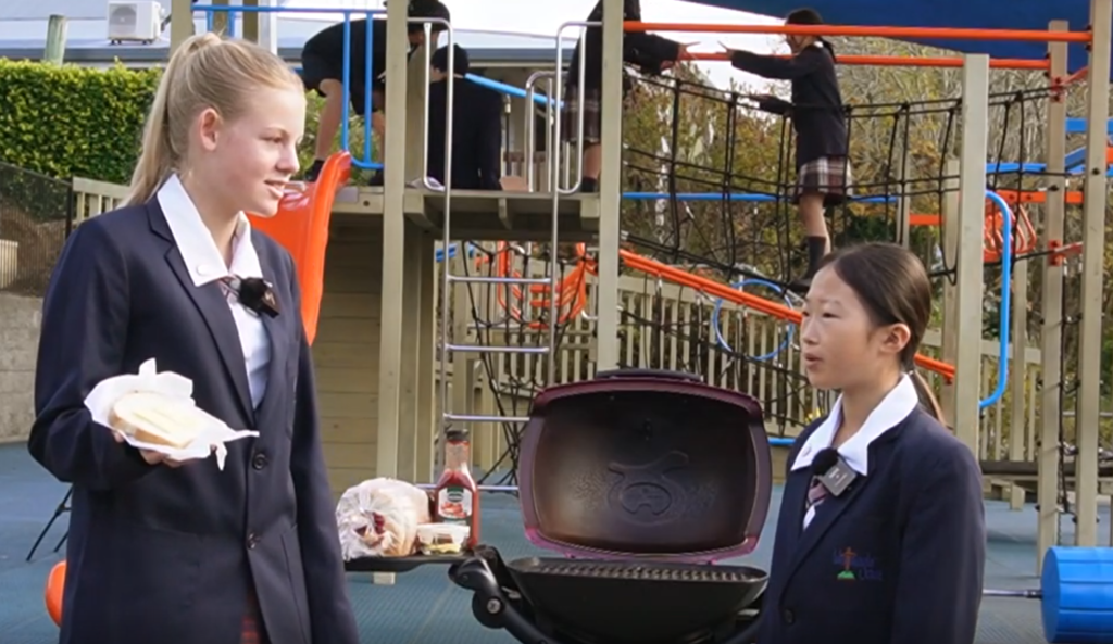 Video thumbnail: students and families sharing a meal at a school event